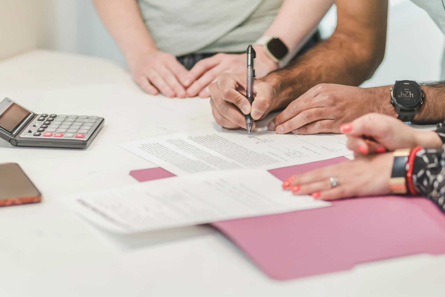 a person wearing wristwatch filling up the paper